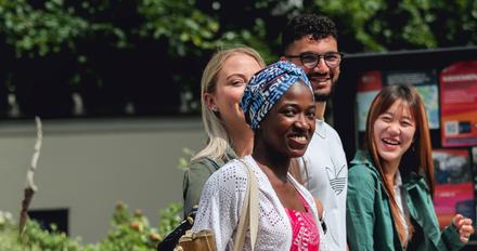 A group of international middlesex university students walk together outside