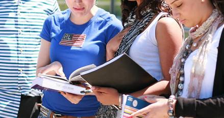Four students reading from books