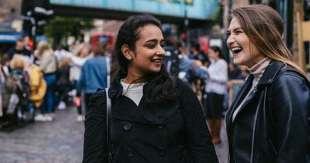 Two students in Camden market laughing
