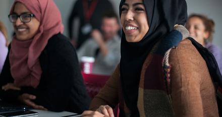 Female students wearing hijabs attending an education studies class