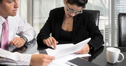 Business-like students reading documents