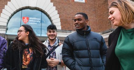 Group of students in front of a red brick building called Middlesex university