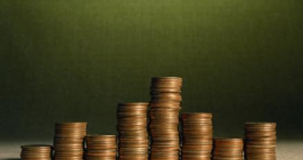 A stack of coins on a green background, symbolizing fees and funding.