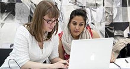 Two Middlesex students working on laptop