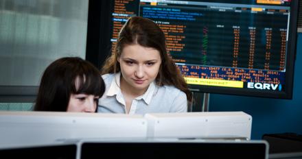 Two students working on a computer at the Financial Markets Lab