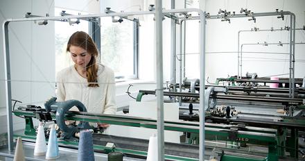 A student working in the knitting workshop