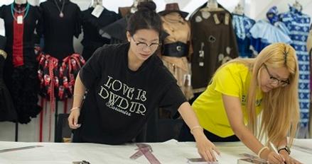 A group of fashion students working in a textiles workshop
