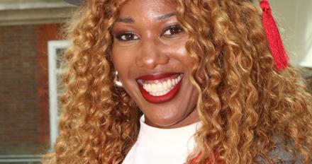 Montell Douglas smiling at the camera and wearing an Honorary Doctor's academic robe