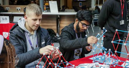 Two younger students trying STEM activities