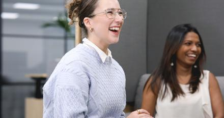 A member of staff laughing with colleagues