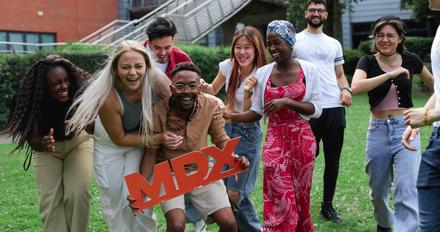 Group of students laughing outside on campus
