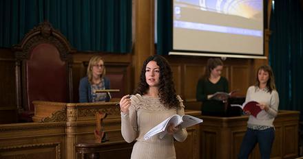 student presents in courtroom-like setting