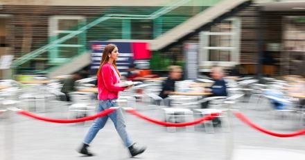 Student walking across foyer