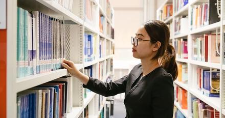 student browsing books in library