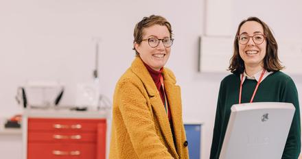 Two smiling female members of staff
