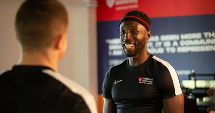 Sports science student laughing with a friend
