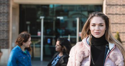 Female student stood outside campus