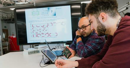 Students working with an ipad.