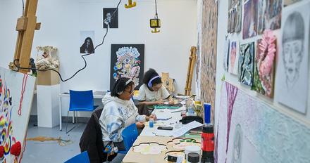 Two students working in art and design studio