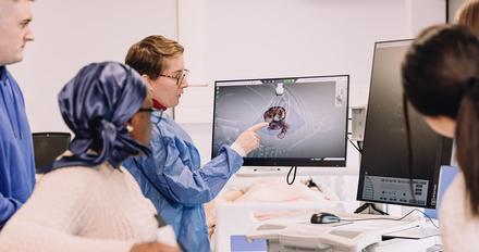 Healthcare science students looking at diagram on a screen
