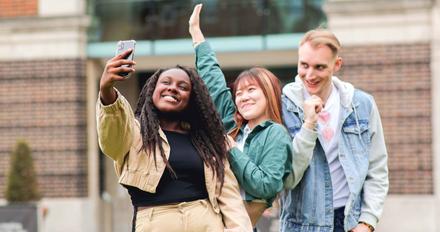 Three students on campus taking a selfie