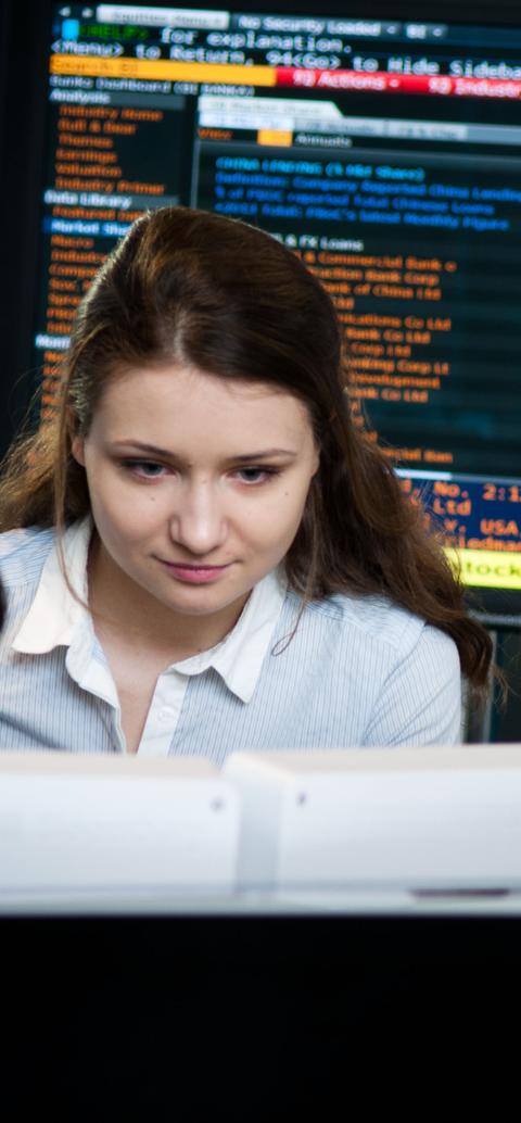 Two students working on a computer at the Financial Markets Lab