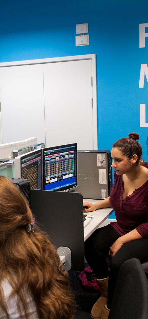 Students use professional market data terminals in a financial markets lab to analyse trading activity and collaborate on investment concepts