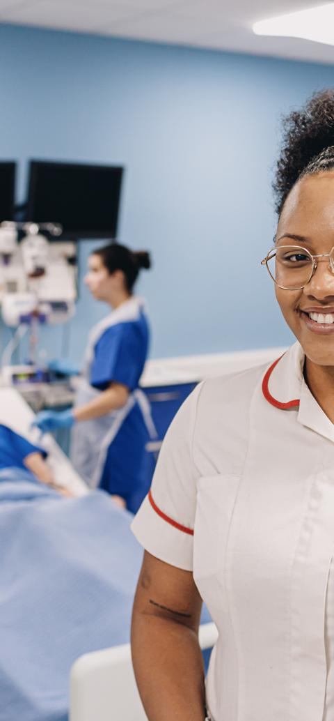 Healthcare students take part in a patient care simulation in a university clinical training environment