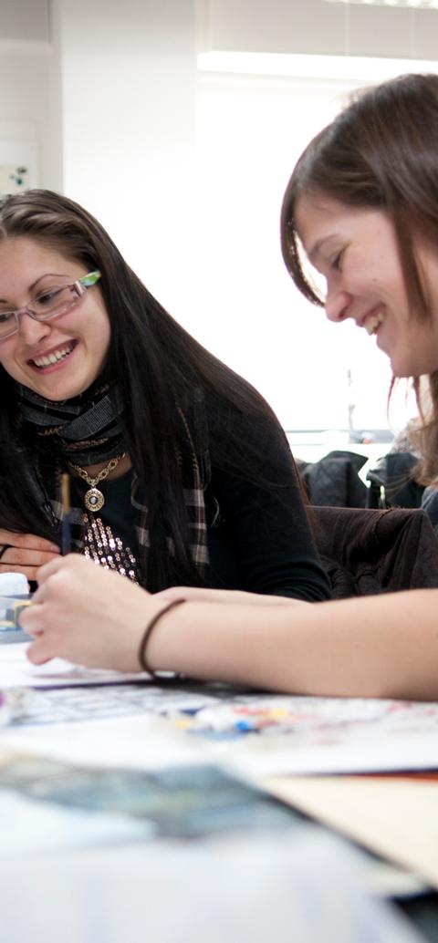 Art and design students work together on a creative project in a university studio