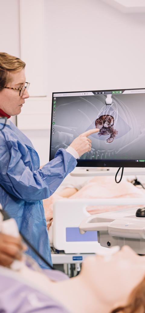 Medical physiology students examine diagnostic images during a practical session in a clinical teaching laboratory.