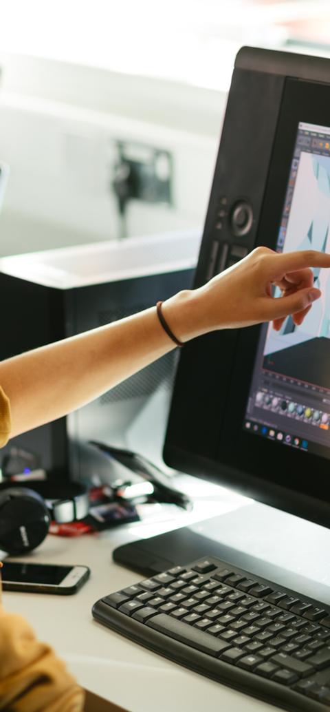 Animation students create and review a 3D digital environment using professional design software.