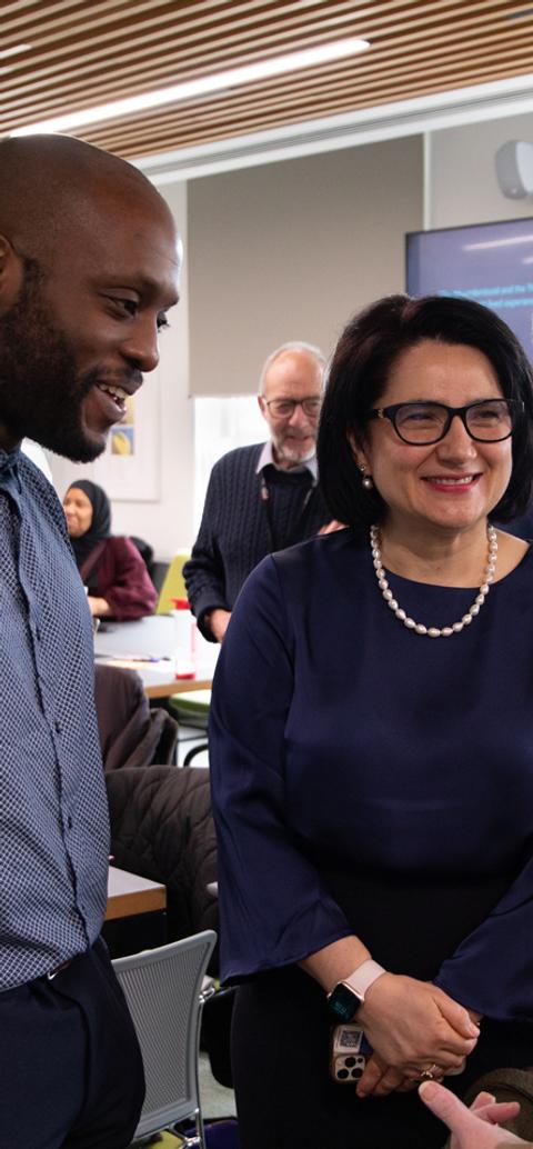 Adults having a friendly chat in a busy room