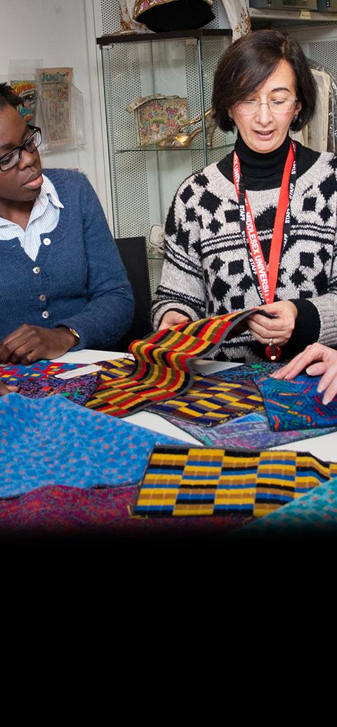 Two women examining fabrics
