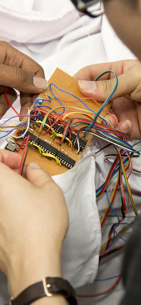 Students holding robotic equipment