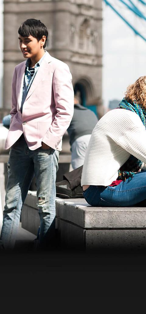 group students having conversation near tower bridge in London