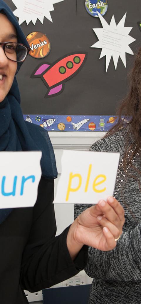 Two women holding up signs