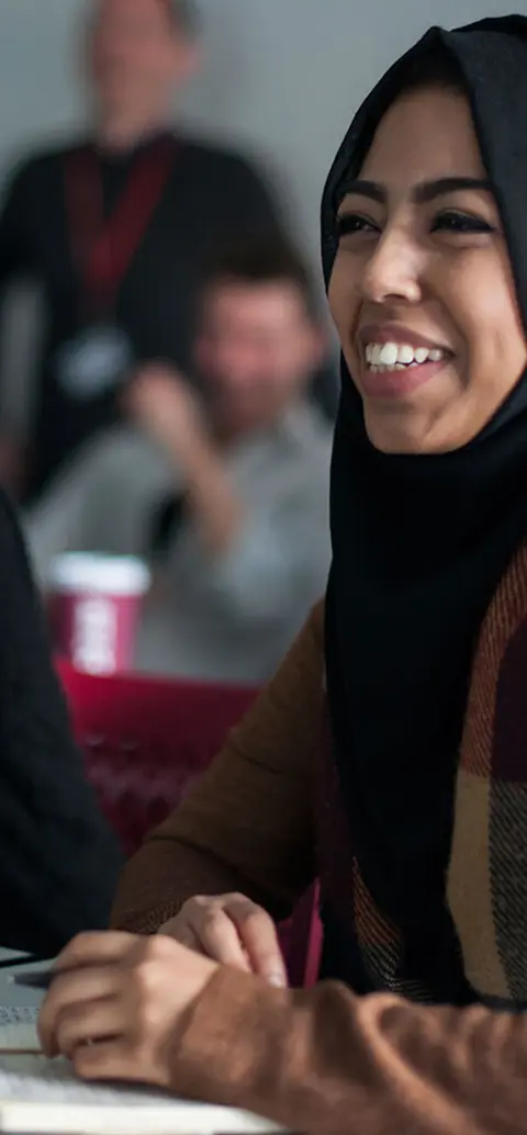 Female students wearing hijabs attending an education studies class