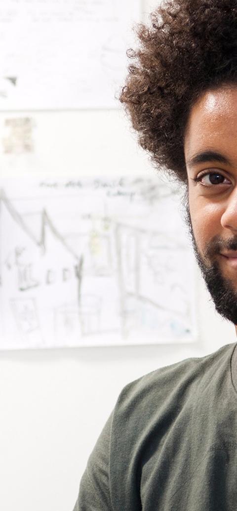 Mixed race student by art board