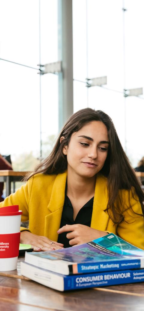 Business students discussing work in university cafe
