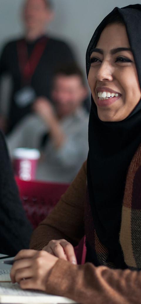 Female students wearing hijabs attending an education studies class