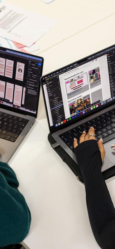 Two students creating content on their laptops