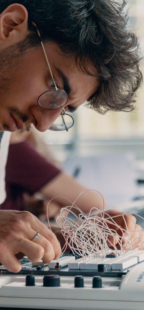 Computer science student working on a pcb
