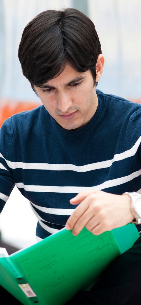 sitting student reading folder