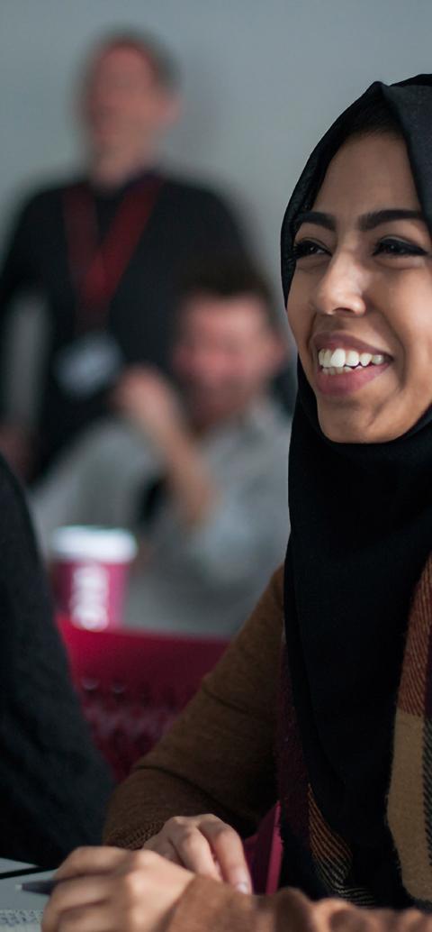 Students smiling in class, listening