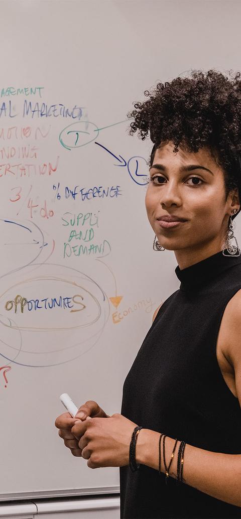 a student writes on a whiteboard