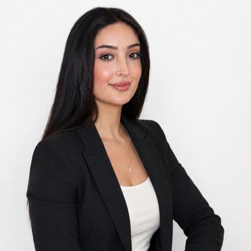 A student sitting against a white background in a photo studio
