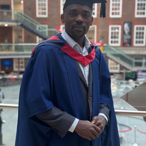 Middlesex university graduate wearing ceremonial clothing.
