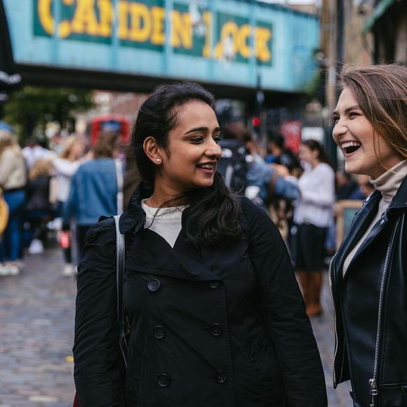 Two students in Camden market laughing