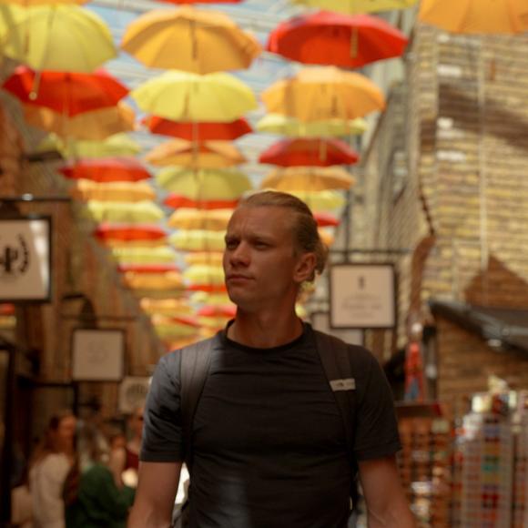 Student walking through market