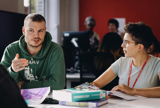 Criminology students discuss course materials and social issues during a seminar session